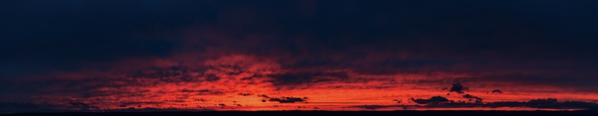 Ideal for sky replacement projects: panoramic aerial shot of a bloody red  illuminated clouds of dark  evening sky just after sunset.