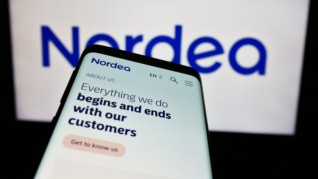 Stuttgart, Germany - 03-15-2024: Smartphone with website of Finnish financial services company Nordea Bank Abp in front of business logo. Focus on top-left of phone display.