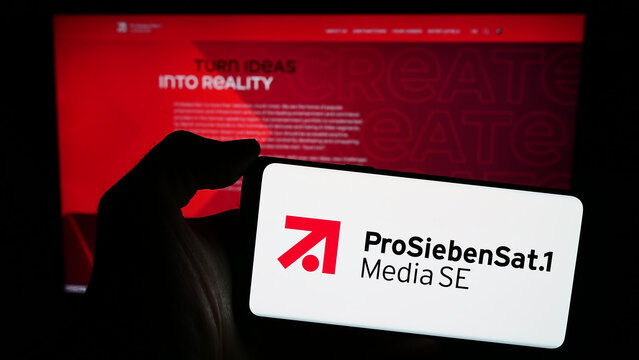 Stuttgart, Germany - 03-15-2024: Person holding smartphone with logo of German television company ProSiebenSat.1 Media SE in front of website. Focus on phone display.