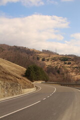 A road with hills and trees on either side of it
