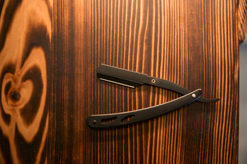 Vintage barber shop razor on wooden background with copy space