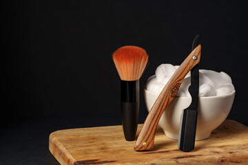 Classic Shaving Equipment With Razor, Brush, and Soap on Wooden Stand Against Dark Background