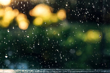 Rain drops on glass for backgrounds rainy fall autumn weather. Abstract background with raindrops on window and blurred daylight. Outside window is blurred bokeh water of city. Copy space