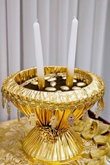 Gold bowl with henna and candles