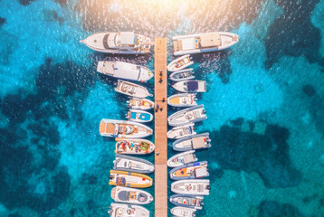Aerial view of boats and luxure yachts in dock in summer day