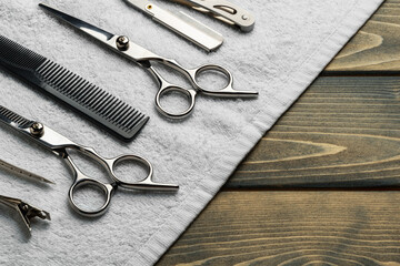 Hairdressing professional scissors on wooden background close up