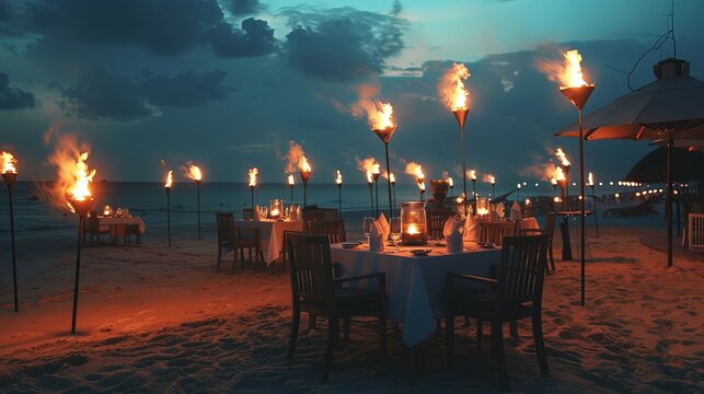 A romantic beach dinner setting under the twilight sky, illuminated by a series of lit torches, creates an enchanting atmosphere for a perfect evening.