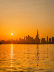 Fototapeta na wymiar amazing sunset view of Dubai Downtown cityline from Dubai Creek harbour