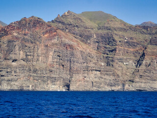 sailing at sea with a catamaran towards the collosal rocks of Los Gigantos in Tenerife