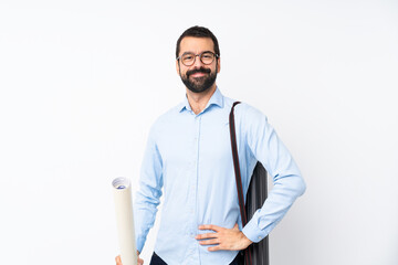 Young architect man with beard over isolated white background posing with arms at hip and smiling