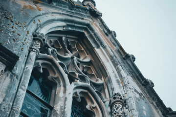 A close-up of an old Gothic window, its intricate tracery and weathered stone standing out starkly against a pure white background