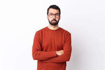 Caucasian handsome man with beard over isolated white background with sad and depressed expression