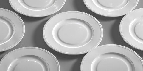 Group of white plates on table, suitable for kitchen or dining room concepts - obrazy, fototapety, plakaty