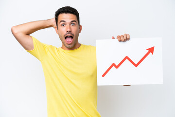 Young handsome man over isolated white background holding a sign with a growing statistics arrow...