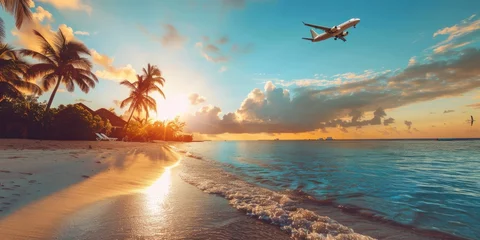 Fototapeten Airplane flying over a beach at sunset, perfect for travel ads © Fotograf