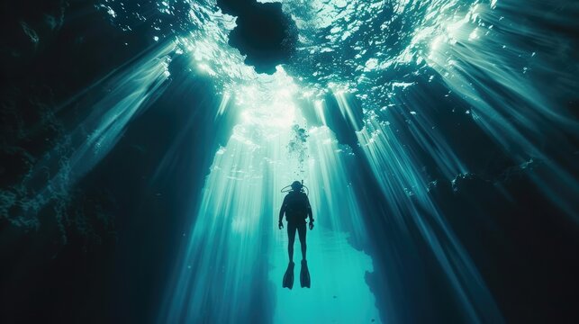 Majestic Blue Hole captured underwater with diver among stalactites and rays of light in Belize's depths