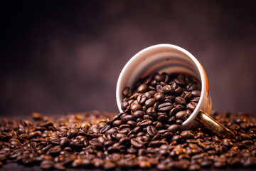many macro aromatic coffee beans in a cup