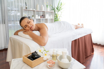 Obraz na płótnie Canvas Caucasian woman customer enjoying relaxing anti-stress spa massage and pampering with beauty skin recreation leisure in day light ambient salon spa at luxury resort or hotel. Quiescent