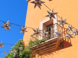 traditional mexican colonial building with star shaped lanterns