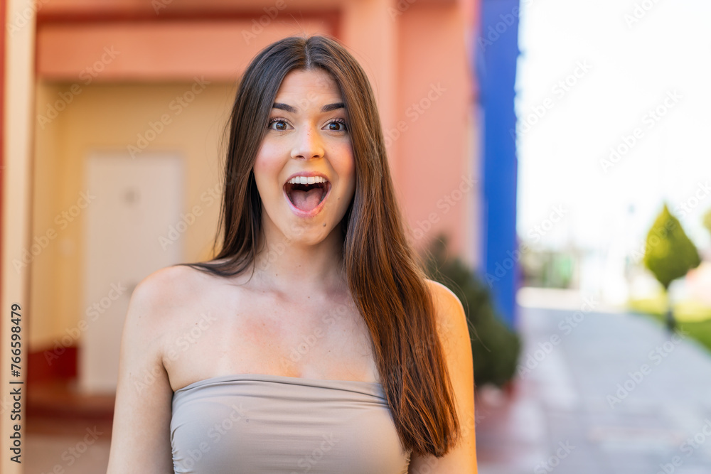 Wall mural Young pretty Brazilian woman at outdoors with surprise facial expression