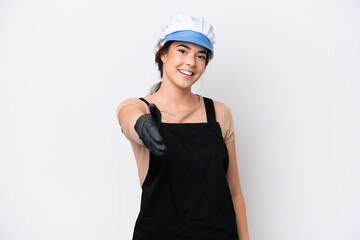 Fishmonger brazilian woman wearing an apron isolated on white background shaking hands for closing a good deal