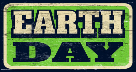 Aged and worn retro earth day sign on wood