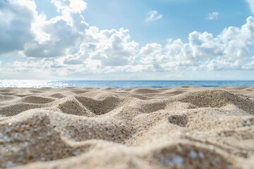 Fototapeta na wymiar Sand on beach on blue sky and ocean background