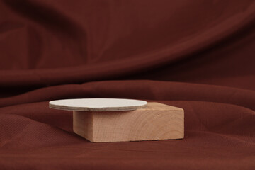 Wooden platform podium on brown silk fabric background. Minimal empty display product presentation scene.