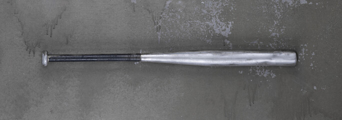 aluminum baseball bat on old background