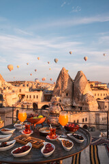 Luxury Exotic Delicious Breakfast Al Fresco - Outdoors on a terrace at sunrise overlooking Goreme,...