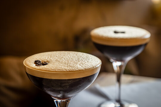 A close up of two Espresso Martini drinks, with focus on foreground