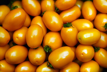 Shop with vegetables. Lots of yellow tomatoes.