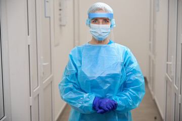 Fototapeta premium Female infectious disease specialist in laboratory in protective equipment