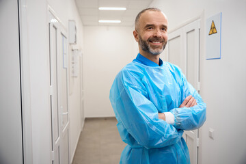 Naklejka na ściany i meble Man with a beard stands in a laboratory corridor