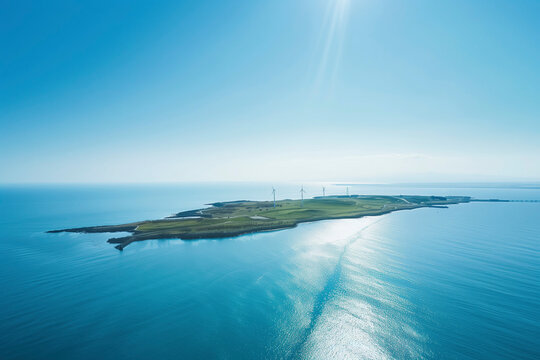 Tranquil island with wind turbines surrounded by calm blue waters