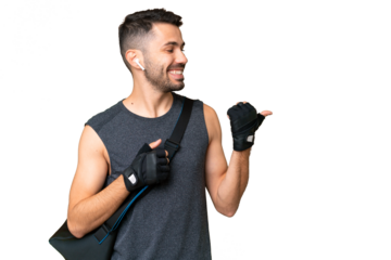 Young sport caucasian man with sport bag over over isolated chroma key background pointing to the side to present a product