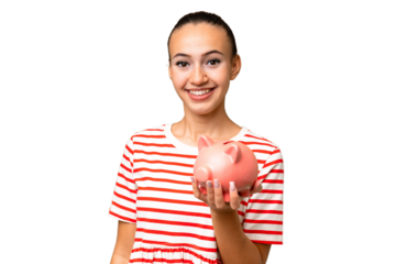 Young Arab woman holding a piggybank over isolated background smiling a lot