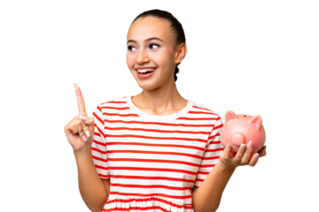 Young Arab woman holding a piggybank over isolated background intending to realizes the solution while lifting a finger up