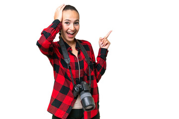 Young photographer Arab woman over isolated background surprised and pointing finger to the side