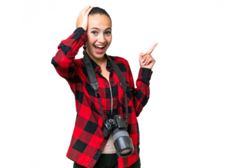 Young photographer Arab woman over isolated background surprised and pointing finger to the side