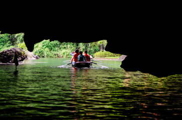 Traditional boat ride in Tam Coc, Ninh Binh. Asia tourism and travel concept