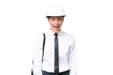 Young architect caucasian woman with helmet and holding blueprints over isolated background with surprise facial expression