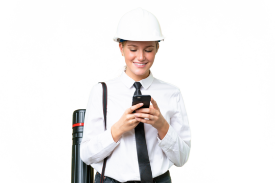 Young architect caucasian woman with helmet and holding blueprints over isolated background sending a message with the mobile