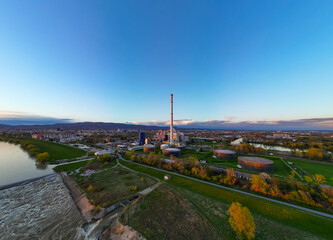 Zagreb city heating plant  built by the Sava riverbank drone perspective at sunset - obrazy, fototapety, plakaty