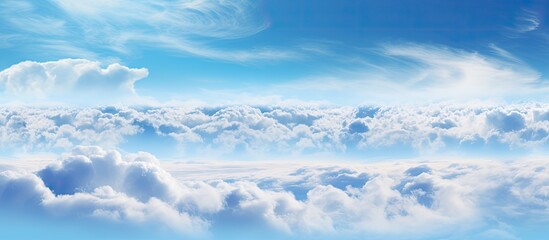 A scenic view capturing a commercial plane flying in the clear blue sky filled with fluffy white clouds - obrazy, fototapety, plakaty
