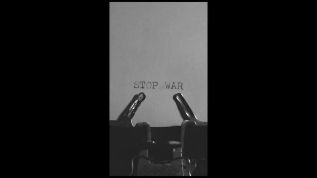 STOP WAR typed words on a vintage typewriter on black white background