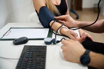Doctor measures a patients blood pressure at a reception