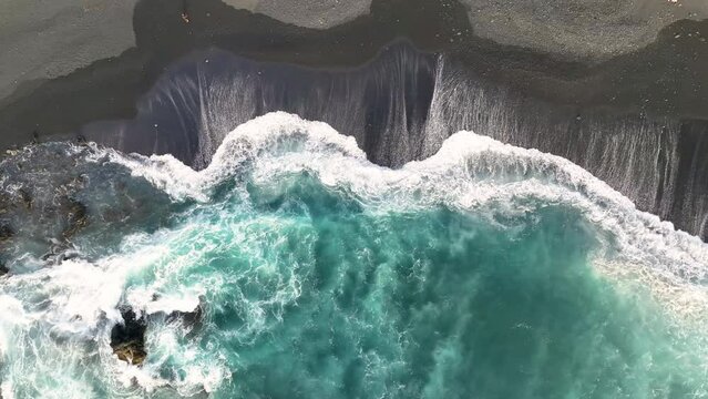 Aerial top view footage of breaking surf with foam in Atlantic ocean. dark ocean waves with white wash.