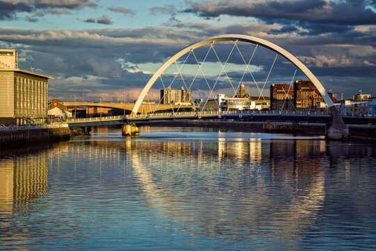 The Clyde Arc in Glasgow with reflections in the river at sunset.