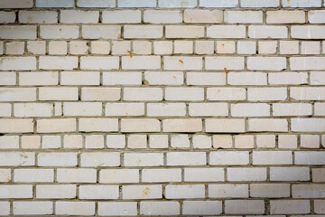 The wall is made of white sand-lime bricks. White brick masonry.
